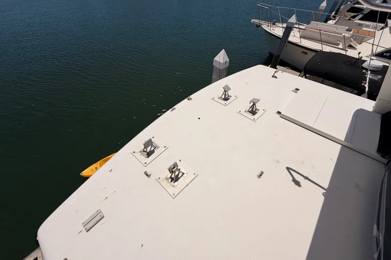 Slide: The Image of 1990 Californian 48 Motor Yacht deck overlooking calm marina waters. - 32