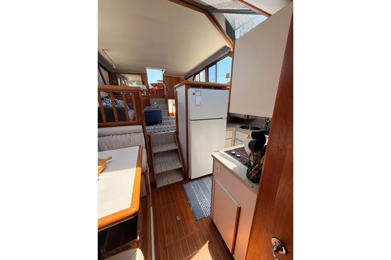 Slide: The Image of Interior of 1990 Californian 48 Motor Yacht with kitchen and seating area. - 81