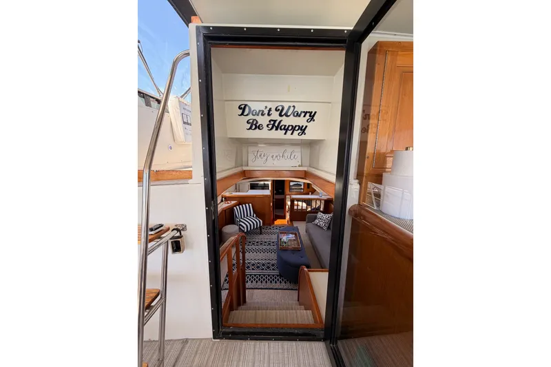 Slide: The Image of Interior view of 1990 Californian 48 Motor Yacht with cozy seating and motivational decor. - 53