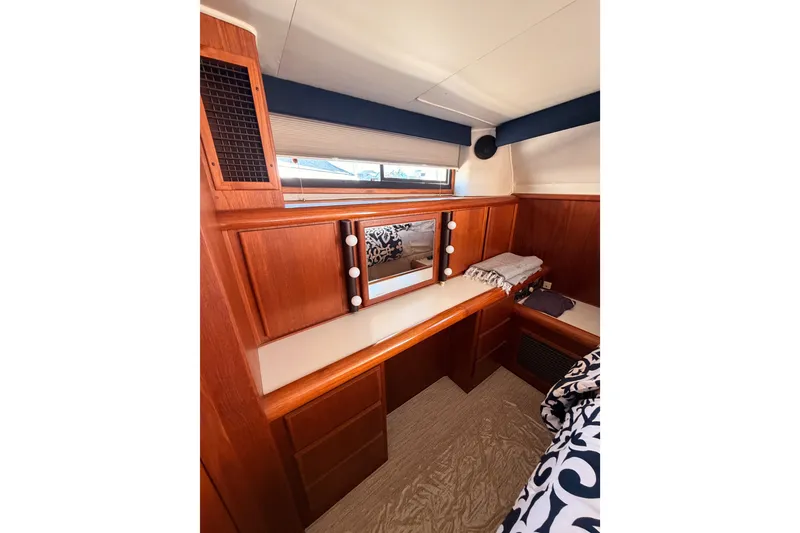 Slide: The Image of Interior of 1990 Californian 48 Motor Yacht with wooden cabinetry and vanity mirror. - 101
