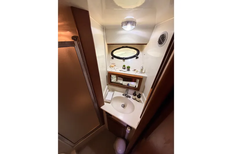 Slide: The Image of Bathroom interior of 1990 Californian 48 Motor Yacht with sink and mirror. - 76