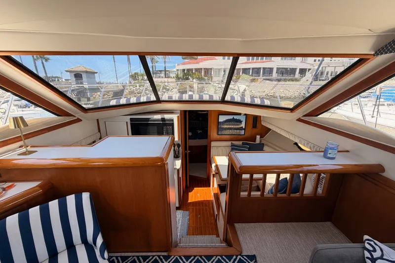Slide: The Image of Interior of 1990 Californian 48 Motor Yacht with wood accents and striped upholstery. - 61
