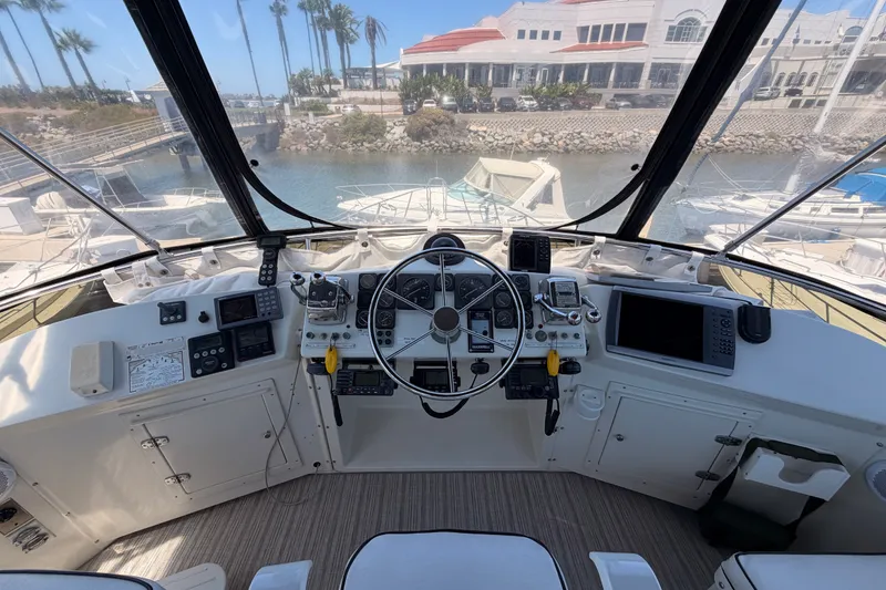 Slide: The Image of Cockpit view of a 1990 Californian 48 Motor Yacht, showcasing navigation instruments and steering wheel. - 37