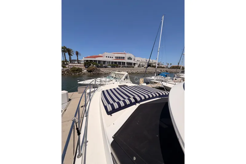 Slide: The Image of 1990 Californian 48 Motor Yacht docked at marina with clear blue sky. - 21