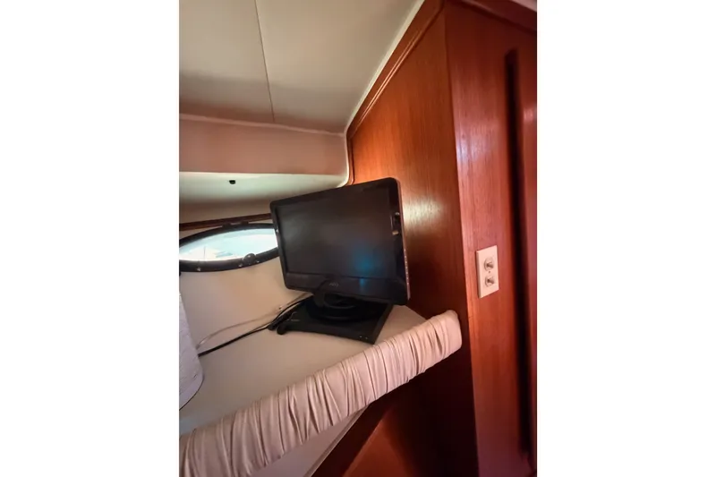 Slide: The Image of Interior of 1990 Californian 48 Motor Yacht with a mounted TV screen. - 73