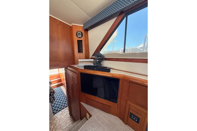 Slide: The Image of Interior of 1990 Californian 48 Motor Yacht with wood paneling and window view. - 89