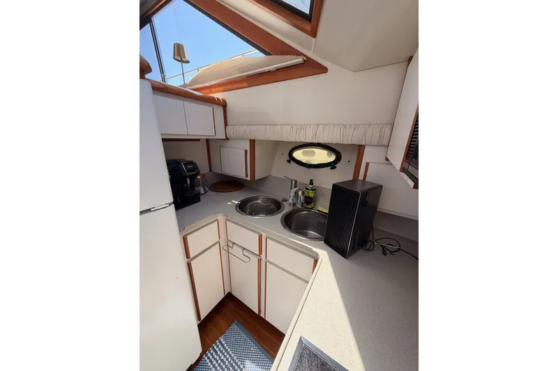 Slide: The Image of Compact kitchen area in a 1990 Californian 48 Motor Yacht with modern appliances. - 65