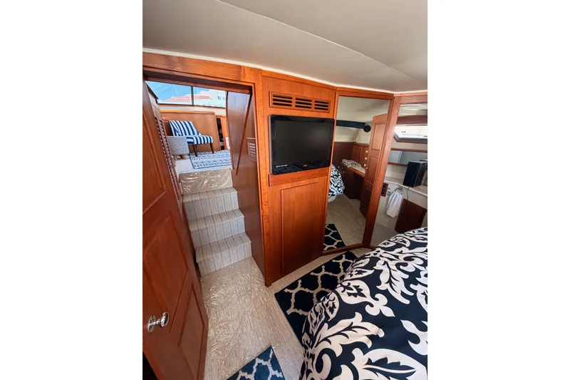 Slide: The Image of Interior of 1990 Californian 48 Motor Yacht with wood paneling and modern amenities. - 99