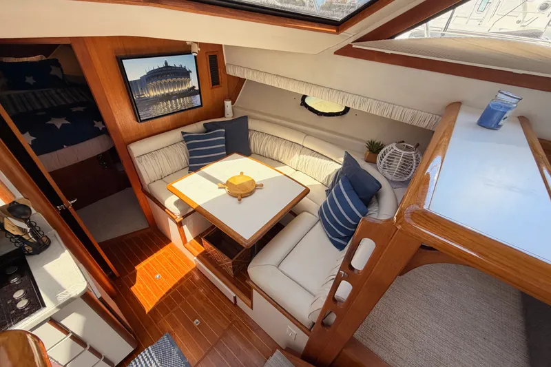 Slide: The Image of Interior of 1990 Californian 48 Motor Yacht with cozy seating and nautical decor. - 62