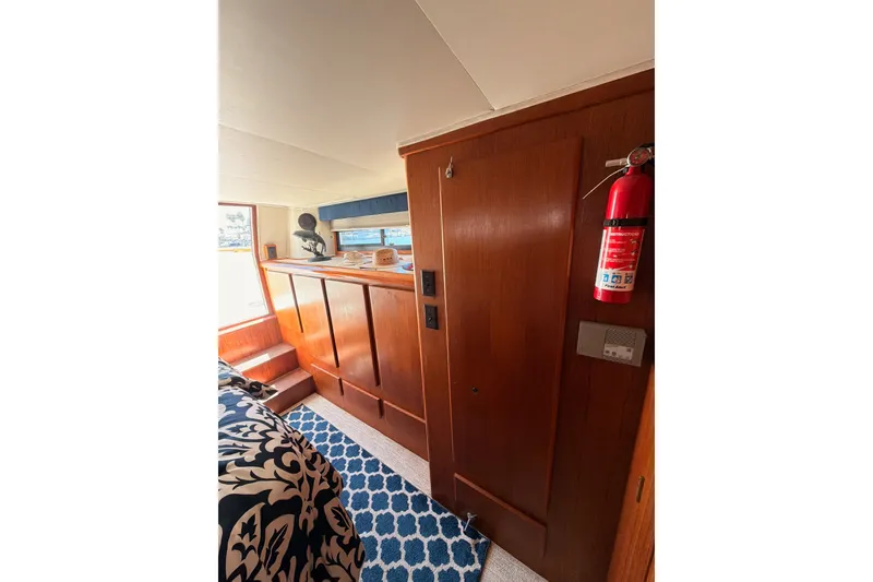 Slide: The Image of Interior of 1990 Californian 48 Motor Yacht with wood paneling and nautical decor. - 96
