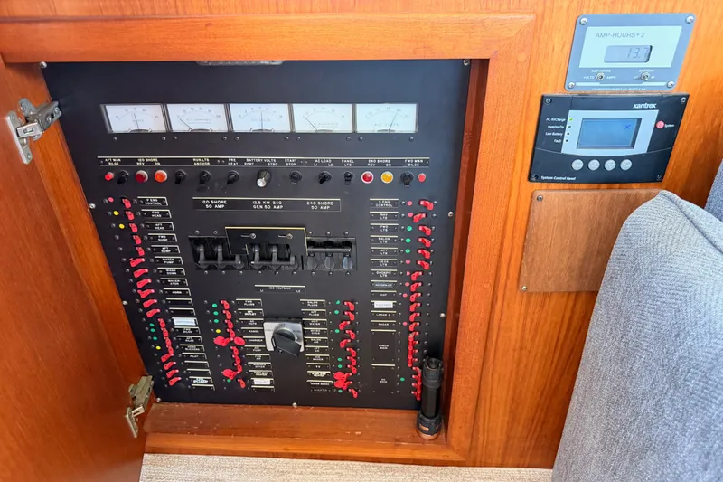Slide: The Image of Electrical control panel on a 1990 Californian 48 Motor Yacht, featuring gauges and switches. - 124