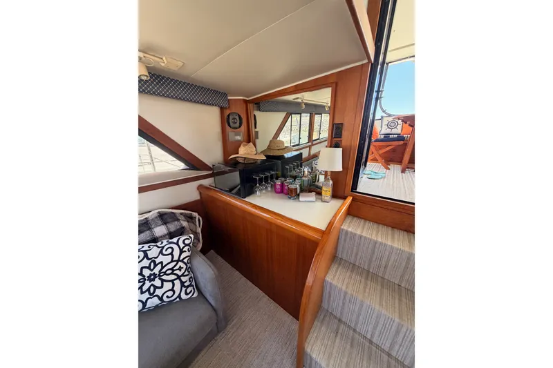 Slide: The Image of Interior of 1990 Californian 48 Motor Yacht with cozy seating and nautical decor. - 57