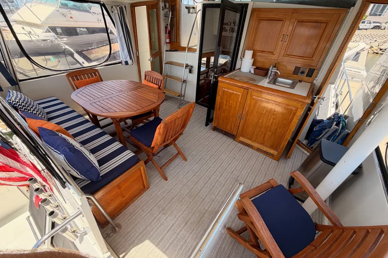 Slide: The Image of Interior of 1990 Californian 48 Motor Yacht with wooden furniture and kitchenette. - 15