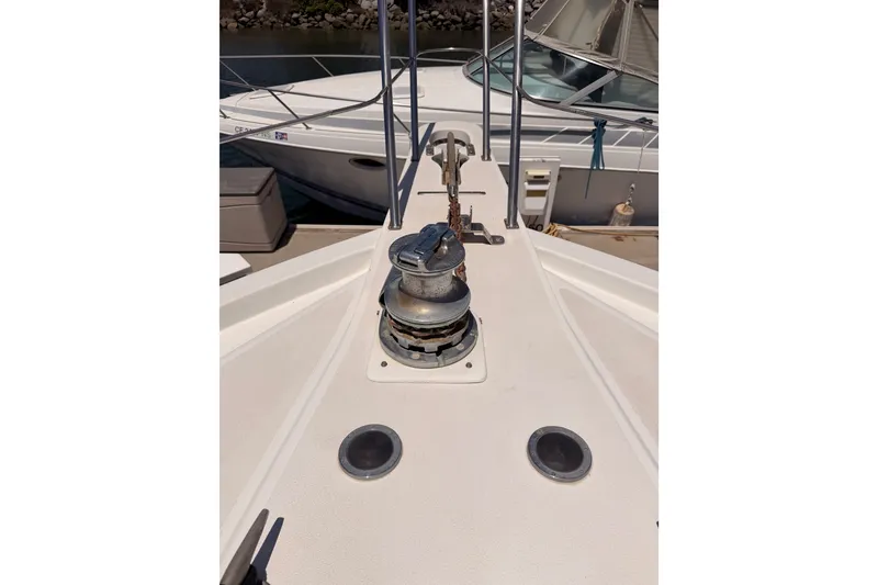 Slide: The Image of Bow view of 1990 Californian 48 Motor Yacht with anchor winch and railing. - 23