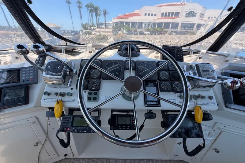 Slide: The Image of Helm of 1990 Californian 48 Motor Yacht with steering wheel and navigation controls. - 41
