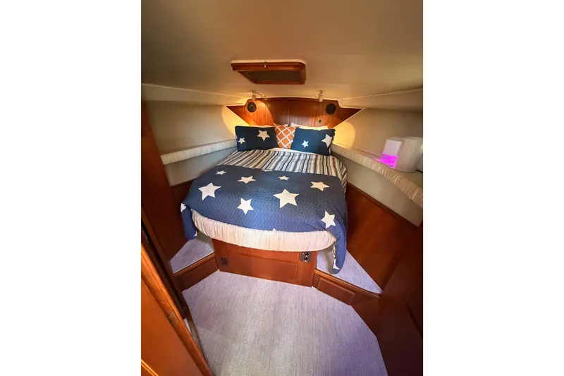 Slide: The Image of Cozy bedroom in 1990 Californian 48 Motor Yacht with star-patterned bedding. - 70