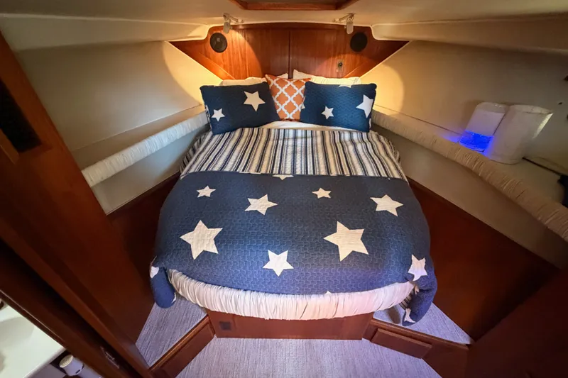 Slide: The Image of Cozy bedroom in 1990 Californian 48 Motor Yacht with star-patterned bedding. - 71