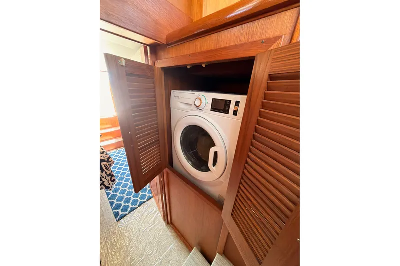 Slide: The Image of Laundry area with washing machine on 1990 Californian 48 Motor Yacht. - 92