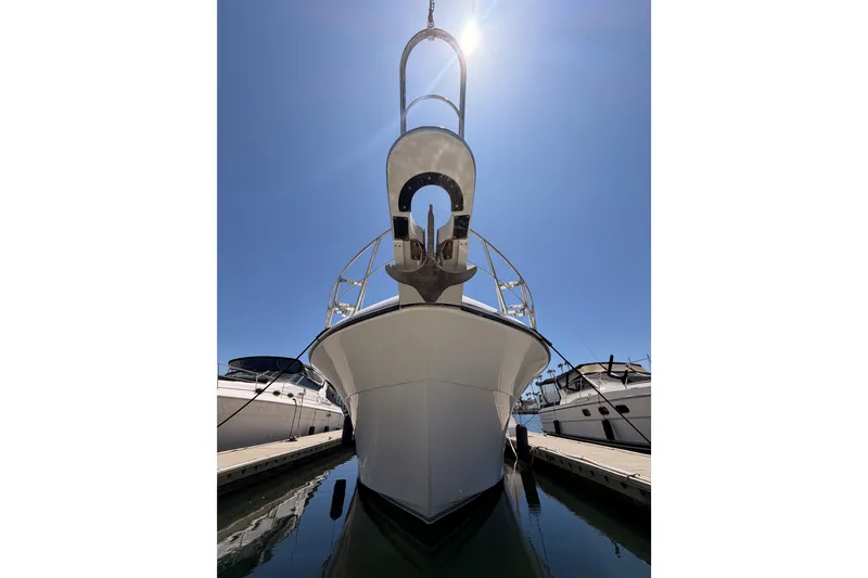 Slide: The Image of 1990 Californian 48 Motor Yacht docked under clear blue sky. - 2