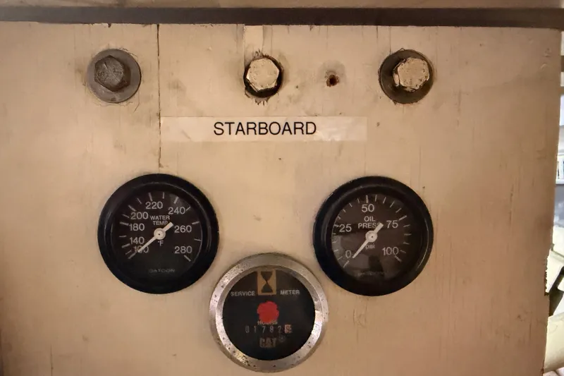 Slide: The Image of 1990 Californian 48 Motor Yacht starboard gauges showing water temperature and oil pressure. - 114