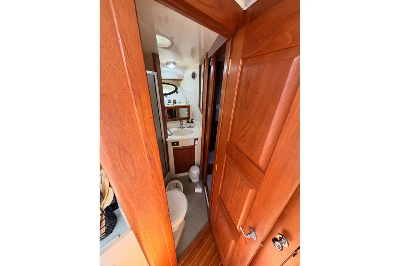 Slide: The Image of Bathroom interior of 1990 Californian 48 Motor Yacht with wooden doors and fixtures. - 69
