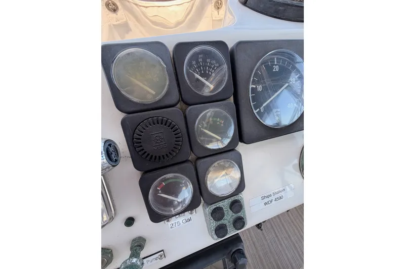 Slide: The Image of Instrument panel of a 1990 Californian 48 Motor Yacht with various gauges and controls. - 46