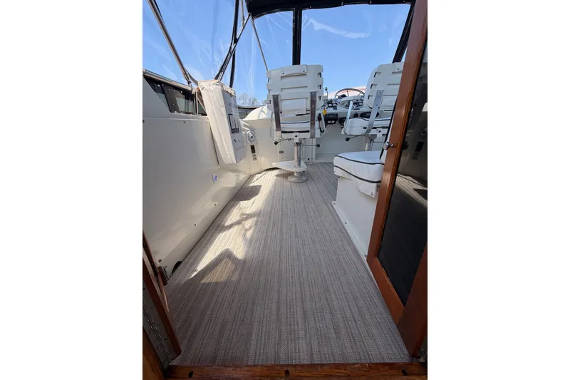 Slide: The Image of Interior view of 1990 Californian 48 Motor Yacht with seating and helm. - 28
