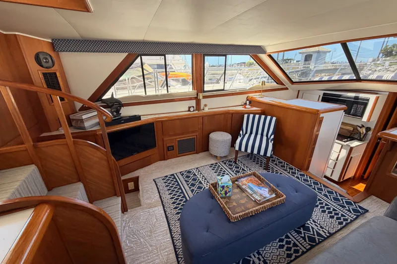 Slide: The Image of Interior of 1990 Californian 48 Motor Yacht with cozy seating and nautical decor. - 59