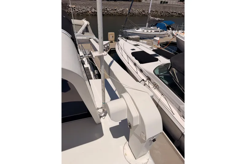 Slide: The Image of 1990 Californian 48 Motor Yacht docked alongside other boats in a marina. - 31