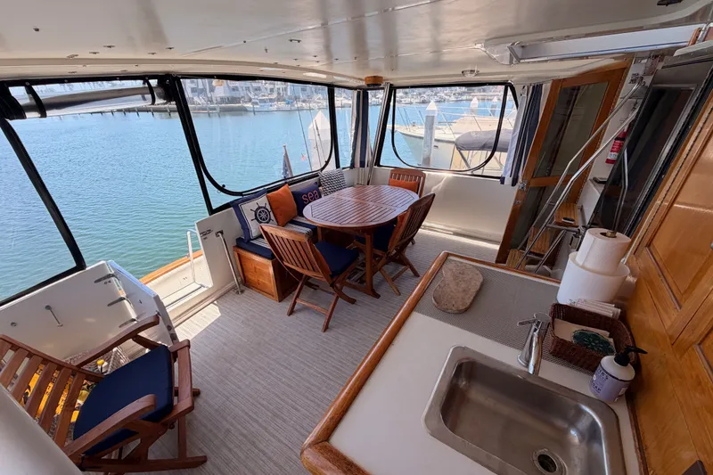 Slide: The Image of Interior of 1990 Californian 48 Motor Yacht with seating and kitchenette. - 17