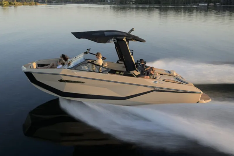 The Image of The image shows a modern motorboat speeding across calm water. - 1
