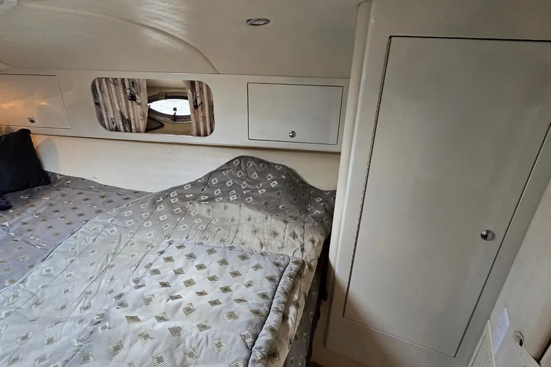 Slide: The Image of Interior cabin of 2000 Wellcraft 45 Excalibur with bed and storage compartments. - 28
