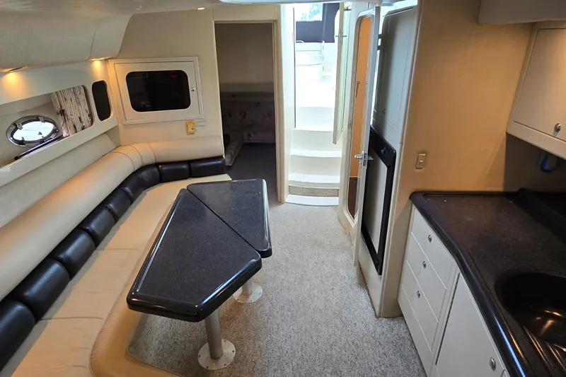 Slide: The Image of Interior of 2000 Wellcraft 45 Excalibur yacht with seating, table, and kitchenette. - 20
