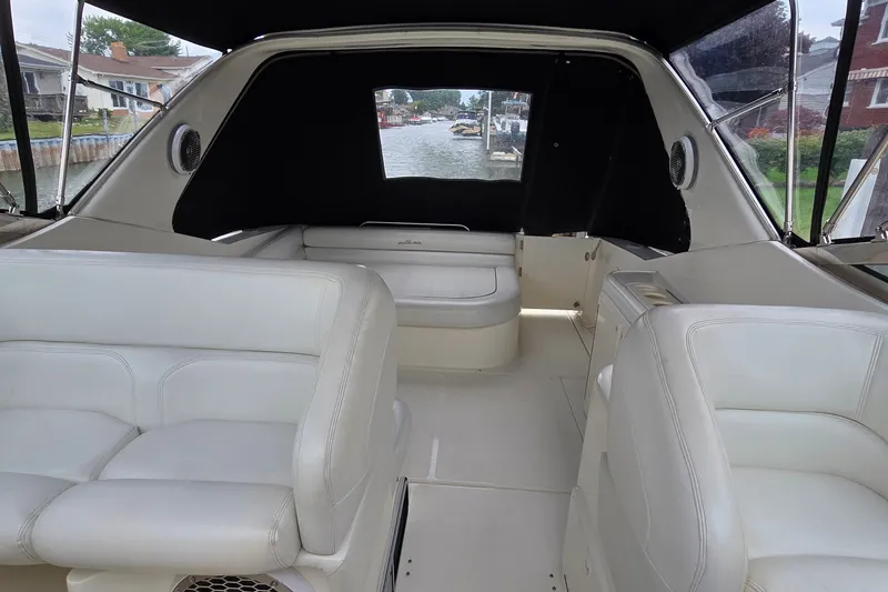 Slide: The Image of Interior of a 2000 Wellcraft 45 Excalibur boat with white seating and waterfront view. - 35