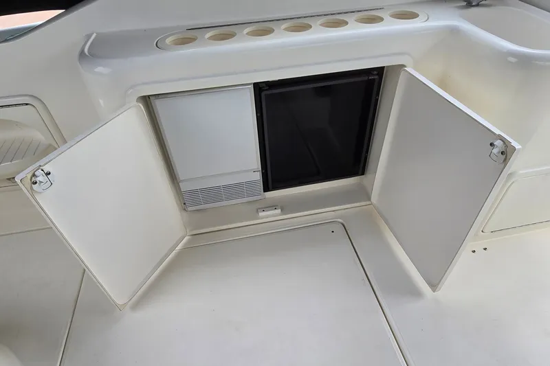 Slide: The Image of Interior view of 2000 Wellcraft 45 Excalibur boat with open storage compartments. - 9