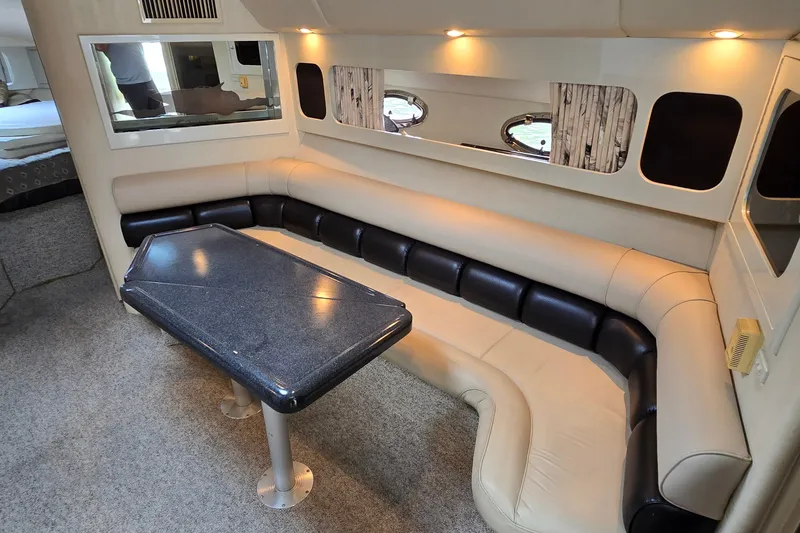 Slide: The Image of Interior of 2000 Wellcraft 45 Excalibur yacht with plush seating and modern table. - 21