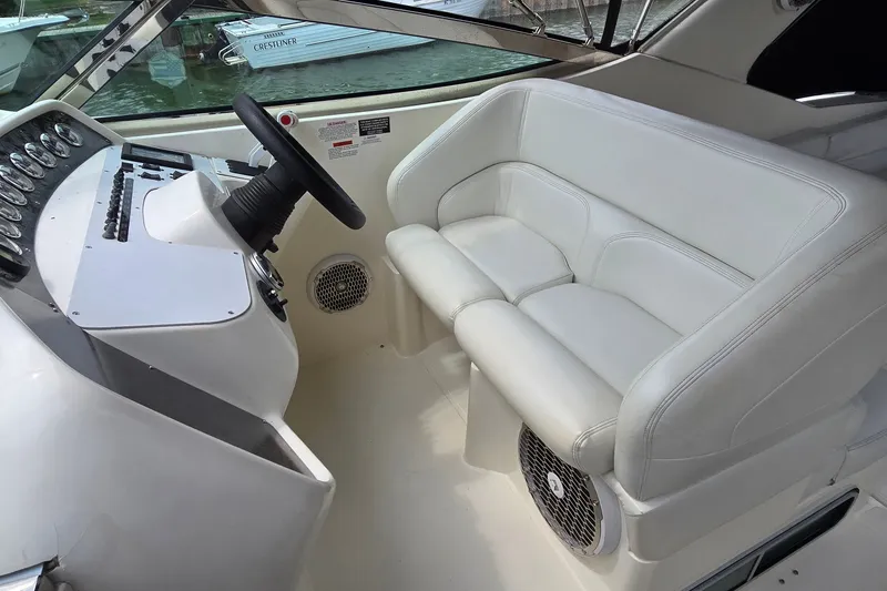 Slide: The Image of Interior of 2000 Wellcraft 45 Excalibur boat with white seating and control panel. - 11
