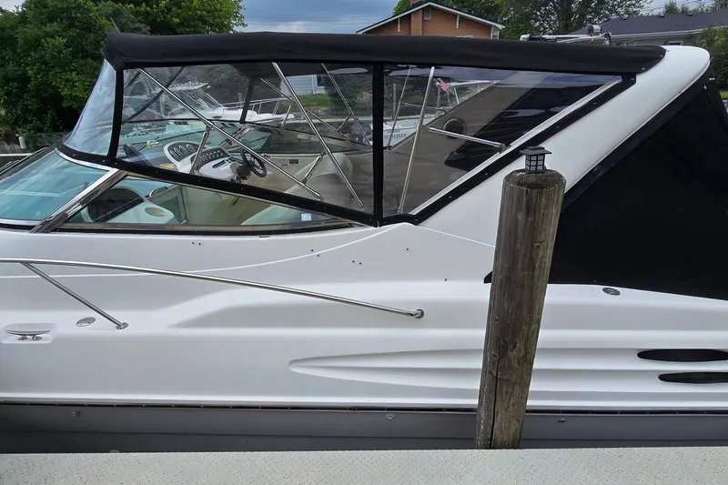 Slide: The Image of 2000 Wellcraft 45 Excalibur boat docked, featuring sleek design and black canopy. - 3