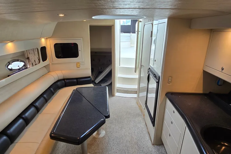 Slide: The Image of Interior of 2000 Wellcraft 45 Excalibur yacht with seating, table, and kitchenette. - 30