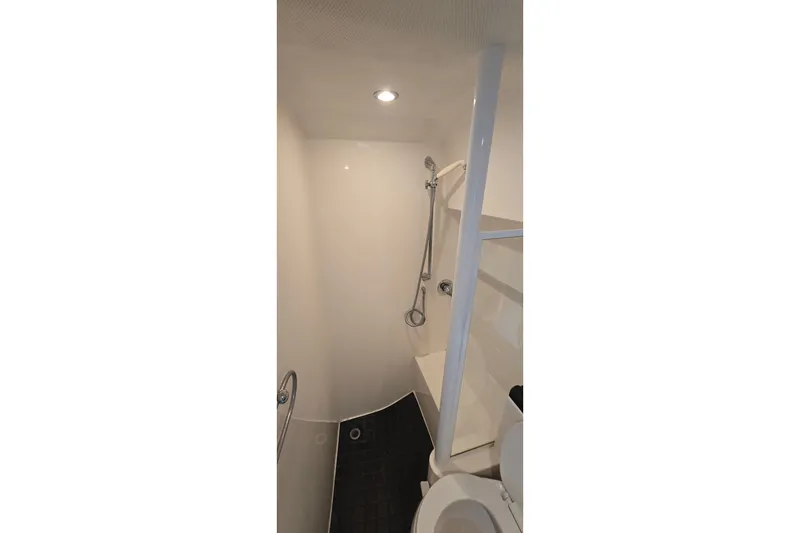 Slide: The Image of Bathroom interior of 2000 Wellcraft 45 Excalibur yacht, featuring shower and toilet. - 34