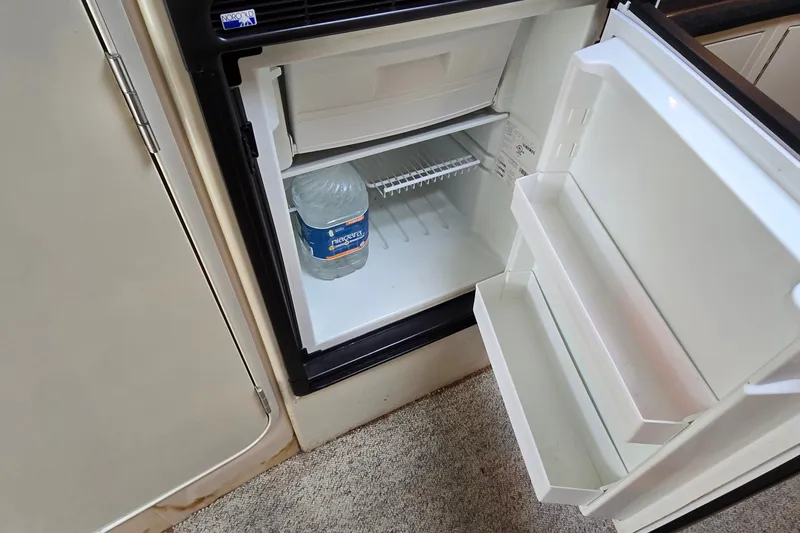 Slide: The Image of Open mini fridge with water bottle inside on Wellcraft 45 Excalibur boat, 2000 model. - 31