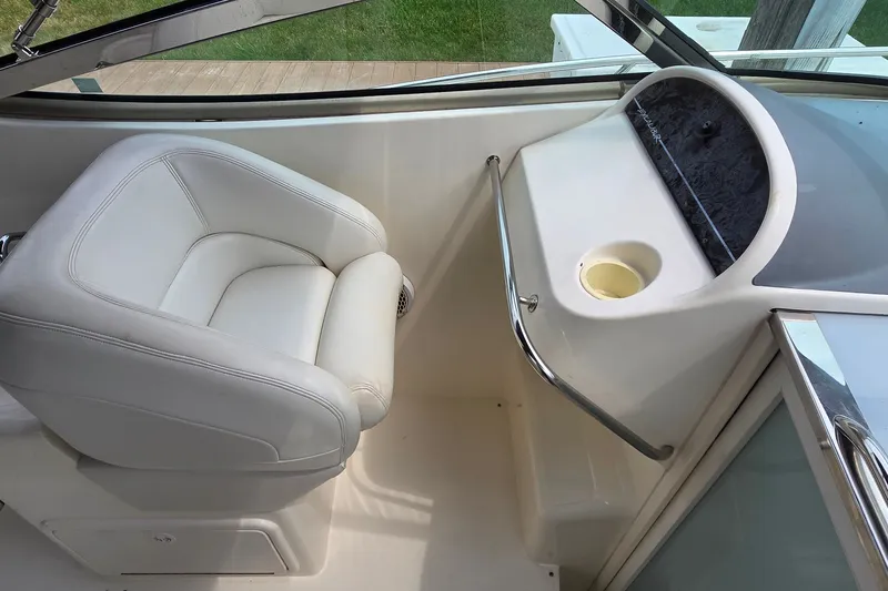 Slide: The Image of Interior of 2000 Wellcraft 45 Excalibur boat with white seating and dashboard. - 12