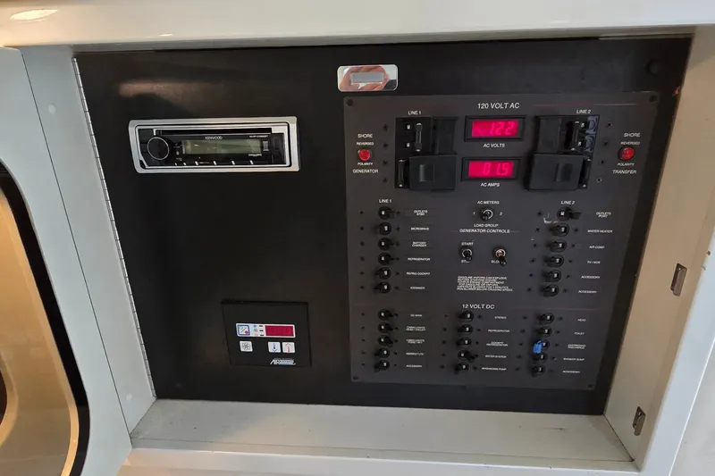 Slide: The Image of Electrical control panel of a 2000 Wellcraft 45 Excalibur boat with Kenwood stereo system. - 25
