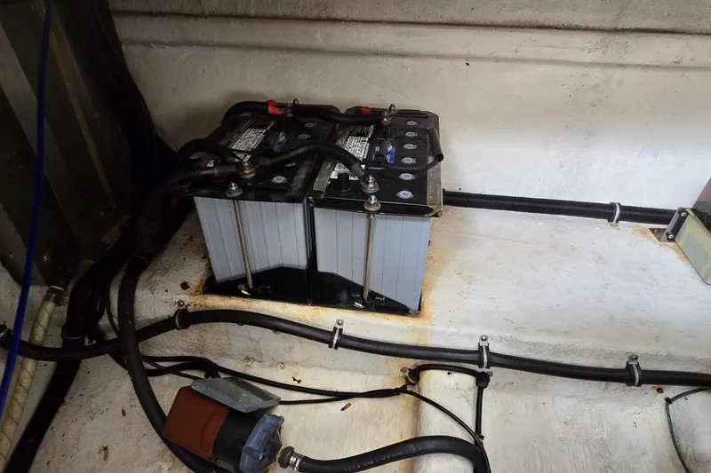 Slide: The Image of Battery compartment of a 2000 Wellcraft 45 Excalibur boat, showing wiring and connections. - 38