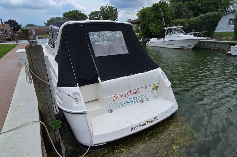 Slide: The Image of 2000 Wellcraft 45 Excalibur boat docked, rear view with "Slice of Paradise" text. - 5