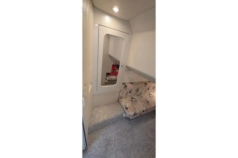 Slide: The Image of Interior cabin of 2000 Wellcraft 45 Excalibur with floral-patterned seating and carpeted floor. - 18