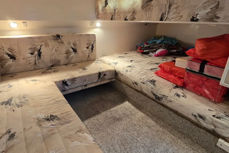 Slide: The Image of Interior cabin of 2000 Wellcraft 45 Excalibur with patterned upholstery and storage. - 19