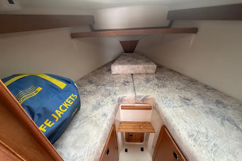 Slide: The Image of Interior cabin of 2003 Catalina 28 MkII sailboat with life jackets and cushioned berth. - 20