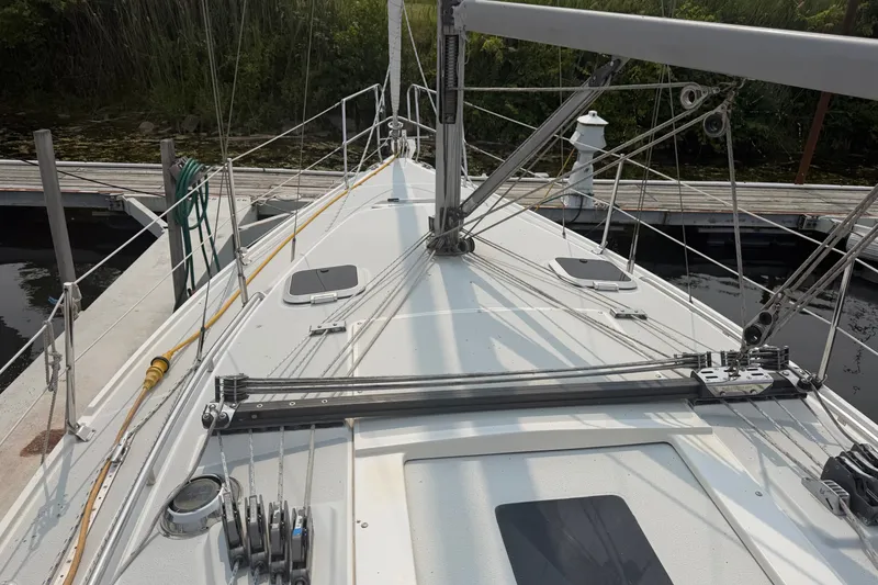 Slide: The Image of 2003 Catalina 28 MkII sailboat docked, showcasing deck and rigging details. - 7