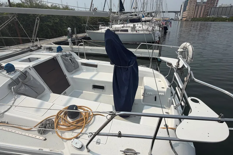 Slide: The Image of 2003 Catalina 28 MkII sailboat docked, featuring a spacious cockpit and covered helm. - 5